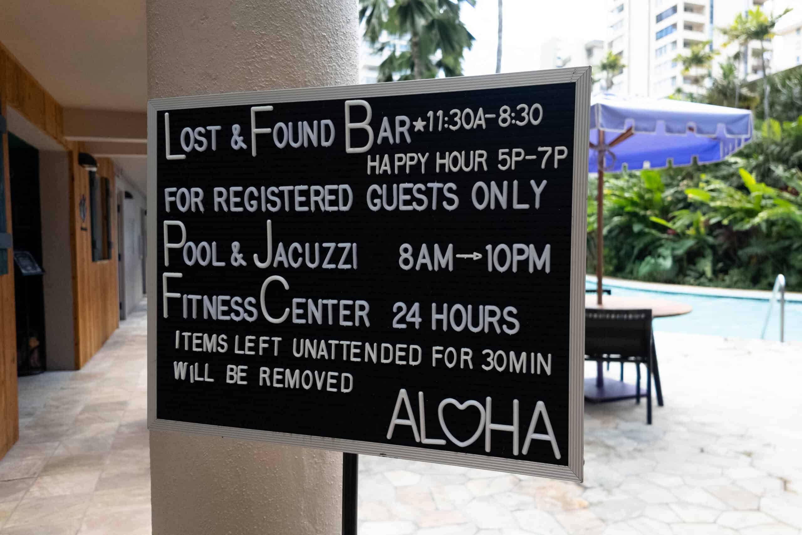 A sign for Lost & Found Bar that gives pool and fitness center information