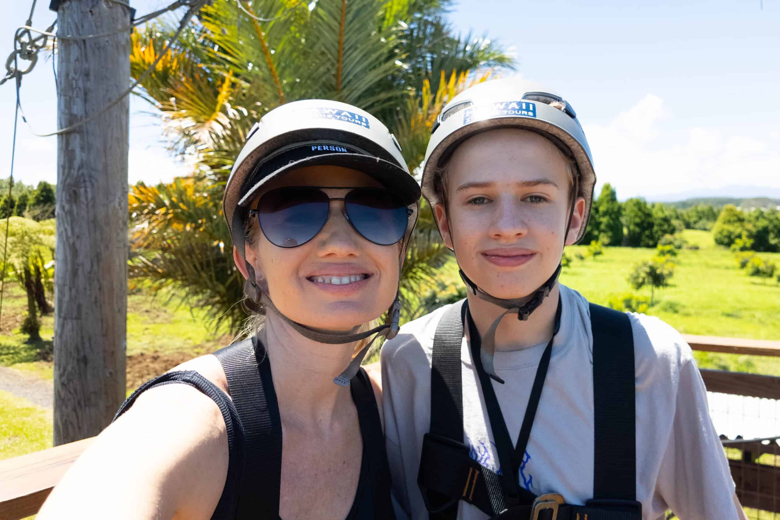 A smiling woman and boy in helmets