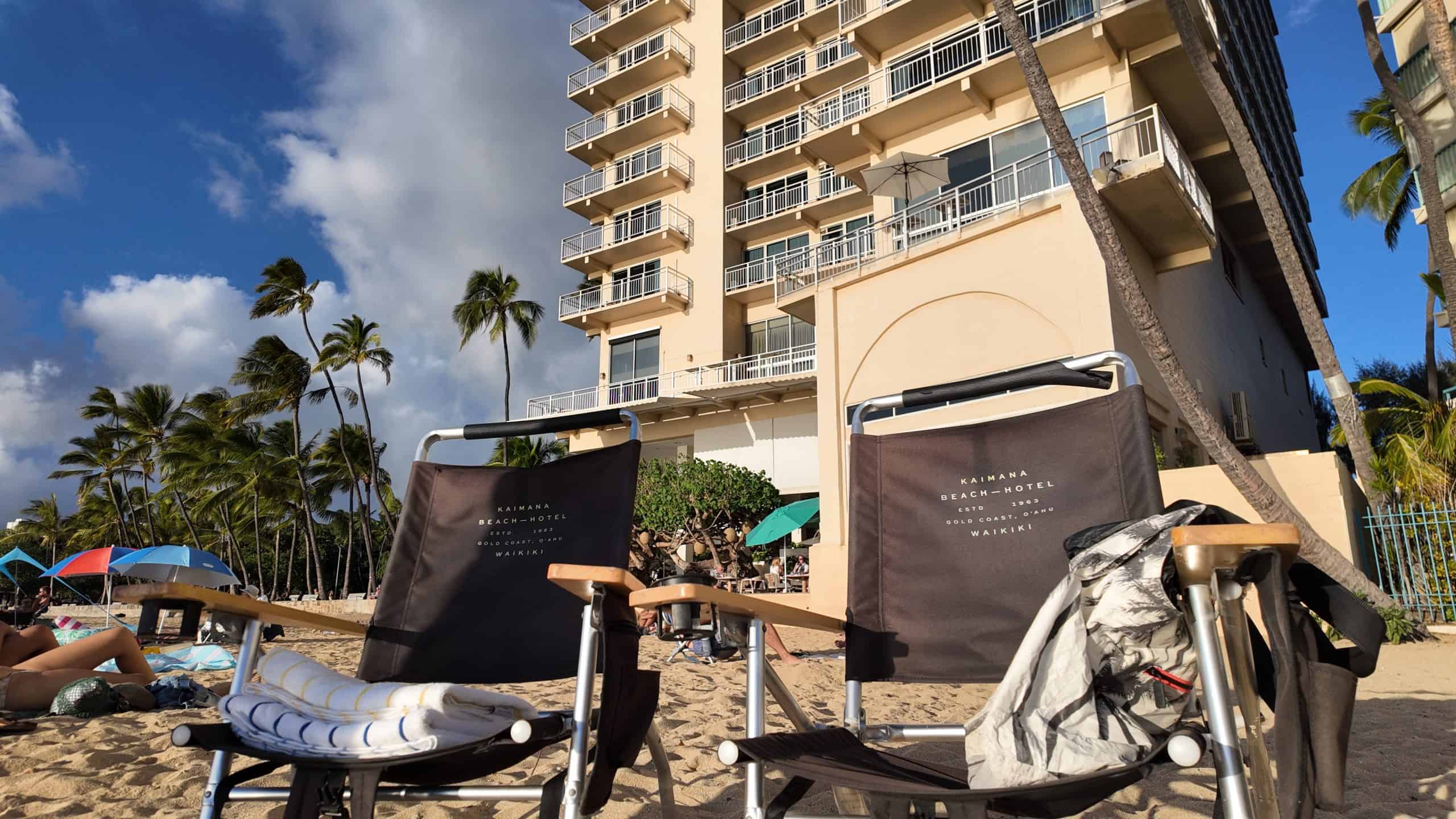 Kaimana Beach Hotel beach chairs with the hotel in the background.