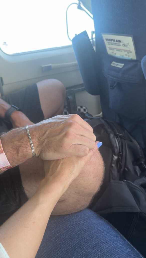 couple-holding-hands-during-flight-on-romatic-caribbean-getaway