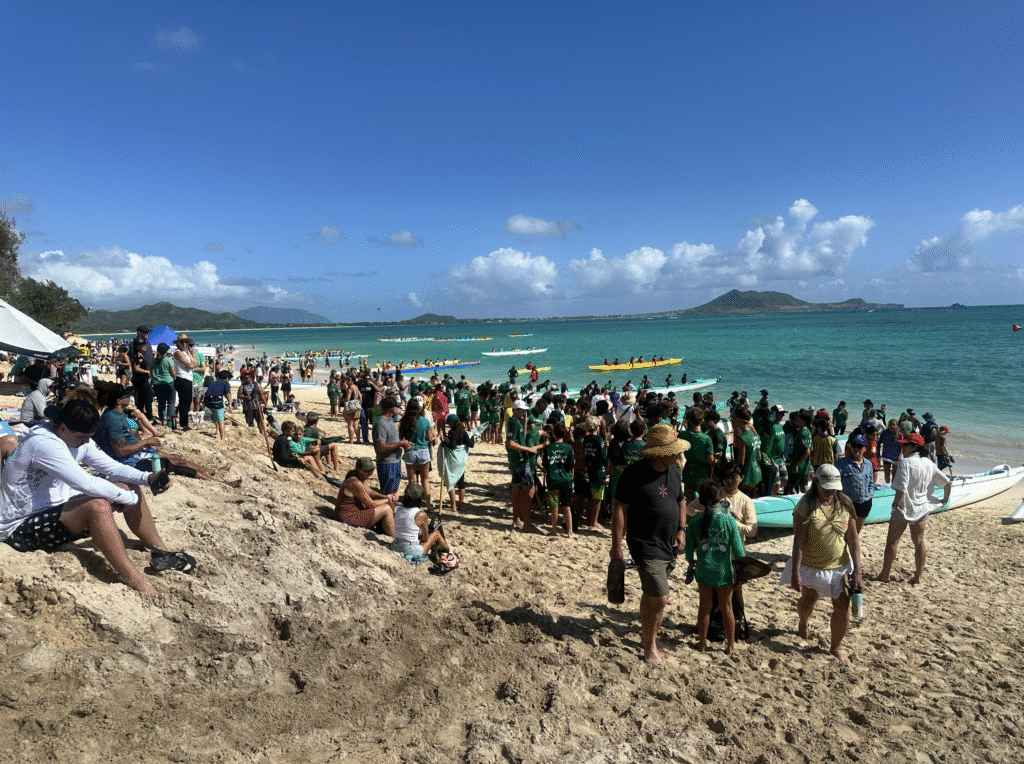 A crowd gathering at Kailua Beach Park for a outrigger canoe competition